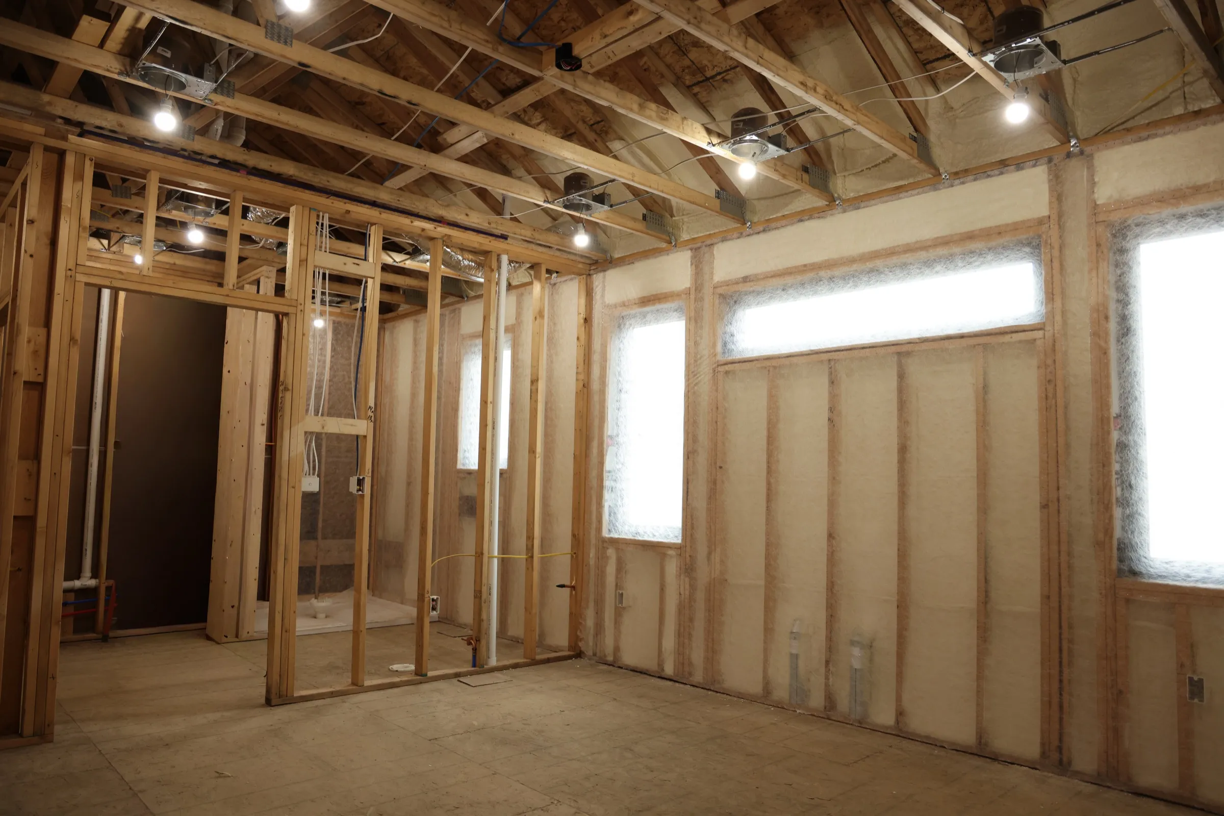 Professional installer applying spray foam insulation in a Fort Mill-area structure